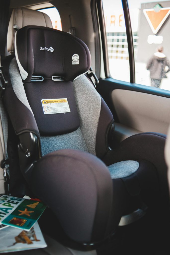child car seat installed in vehicle back seat